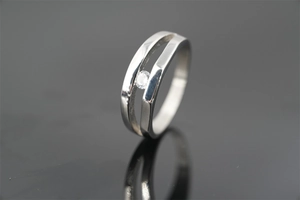 Detail of silver double-layered ring featuring a central sparkling zircon inlay