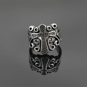 Retro gothic cross ring in titanium steel with intricate filigree details and mirror reflection