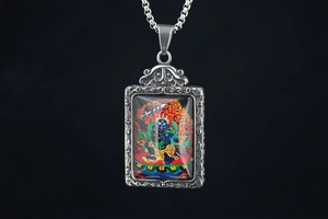 Macro shot of a vintage titanium steel pendant with a colorful religious deity illustration