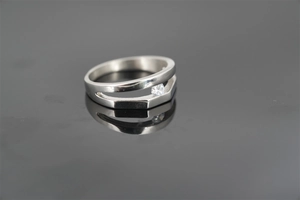 Detail of minimalist double-layered silver ring with a sparkling round zircon stone