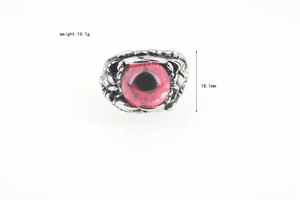 Macro view of gothic punk serpent devil eye ring with red eyeball and eagle claw details