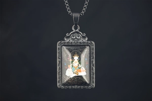 Detailed close-up of retro titanium steel Buddha pendant with intricate carved edges
