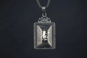 Macro shot of Buddhist Thangka pendant with intricate metal carving and box chain