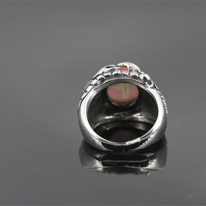 Retro punk style stainless steel ring featuring a vintage snake eye with red gemstone
