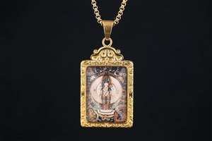 Detailed macro view of golden Thangka pendant with colorful Buddha and floral relief