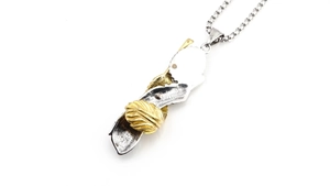 Detail view of retro turquoise feather pendant with silver and gold Indian silhouette