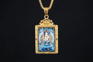 Detailed close-up of a gold-plated Buddhist Manjushri pendant with Thangka art and clouds