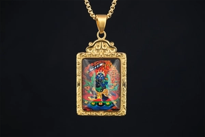 Detailed macro view of the gold-plated Thangka deity pendant with intricate floral relief