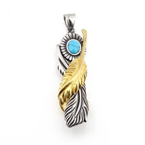 Vintage turquoise feather pendant in retro punk style with gold and silver accents