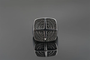 Macro shot of punk style square titanium steel ring with cross pattern and vintage finish