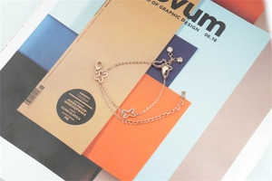 Close-up of rose gold double-layer butterfly bracelet with zircon accents on a magazine