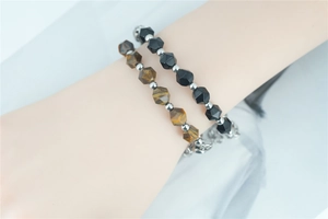 Detail view of tiger eye and black stone beaded bracelet set with silver steel beads