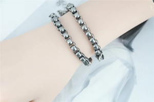 Close-up of matte silver industrial style double chain bracelet on a model's wrist