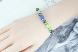 Detailed shot of beaded bracelet with turquoise stones and hematite on model wrist