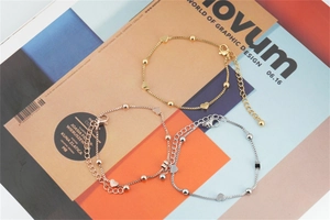 Three-tone titanium steel bracelet set featuring heart charms and adjustable clasps