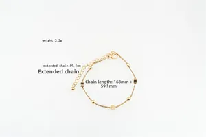 Detailed view of a gold heart pendant bracelet with beads and adjustable lobster clasp
