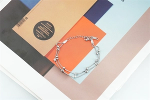 Detail view of double-layer stainless steel star charms with box chain and lobster clasp