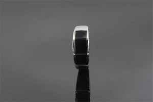 Macro detail of men's silver steel ring with flat black onyx inlay and smooth polished edges