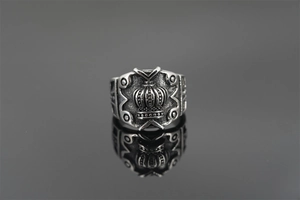 Macro detail of vintage crown relief on a retro steel ring with textured antique finish