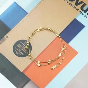 Minimalist double-layered gold star bracelet with square chain link and adjustable lobster clasp
