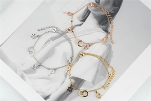 Detailed view of three minimalist hexagram star bracelets in silver, gold, and rose gold