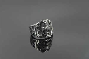 Detail of vintage titanium steel crown ring with cross patterns and retro oxidized finish
