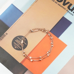 Double-layered rose gold stainless steel bracelet with star charms and beads for women