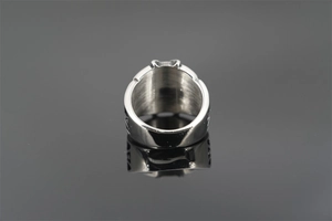 Macro shot of retro crown ring in titanium steel with detailed embossed texture and silver gloss