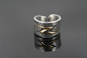 Close-up of vintage wide ring showing hammered texture and gold lightning bolt design