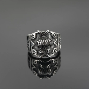 Retro titanium steel crown ring in vintage silver finish with gothic relief on black background