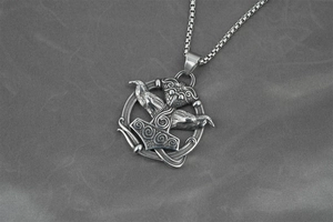 Macro shot of Viking Mjolnir pendant with detailed ravens on a sturdy steel box chain