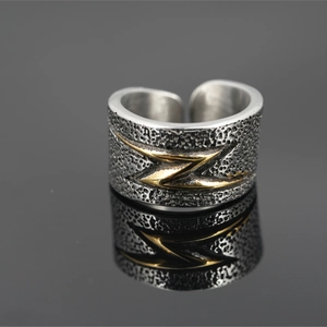 Vintage punk style wide silver ring with golden lightning symbol and hammered texture