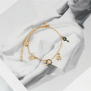 Elegant gold hexagram star and key charm bracelet with interlocking circles and crystals