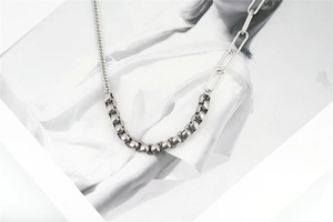 Detail showing asymmetrical Cuban link and paperclip chain joints in stainless steel