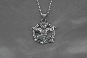 Detailed close-up of a Viking Mjölnir pendant with Odin's ravens and Celtic knots