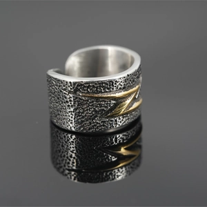 Vintage distressed wide band ring with gold lightning bolt icon on textured metal