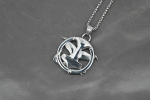 Detail of Viking Mjölnir pendant with raven wings on a stainless steel box chain