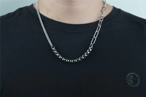 Detailed view of silver stainless steel asymmetric拼接 Cuban chain necklace for men