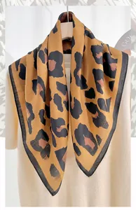 Detailed view of leopard print square scarf featuring classic herringbone weave texture