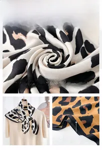 Detail of leopard print scarf showing herringbone texture and refined edge stitching