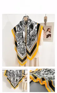 Detail shot of the vintage forest landscape print and contrasting borders on the silk scarf