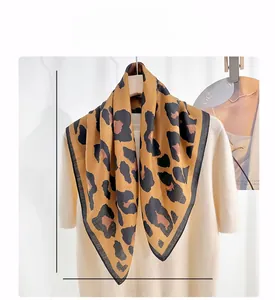 Detail view of leopard print square scarf featuring premium herringbone texture and fine edges