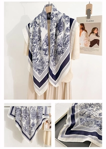 Detailed close-up of navy blue Toile de Jouy scarf with vintage lion and forest patterns