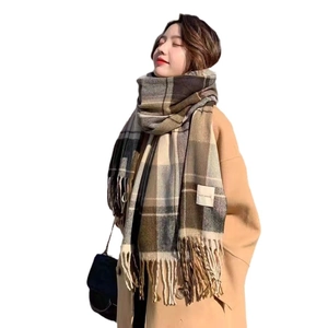 Thick plaid tassel scarf in coffee and beige tones with a white branded label