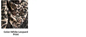 Detailed close-up of leopard print scarf texture with fine fringe edges in leopard white