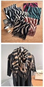 Detailed view of zebra print cashmere feel scarf with soft fringe edges and striped texture