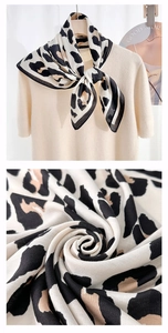Detail showing high-quality leopard print silk scarf paired with cream knit sweater