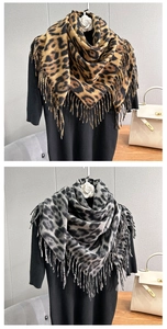 Detail of leopard print scarf featuring thick fringe edges and soft cashmere-like texture
