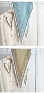 Detailed view of light blue and champagne silk-like diamond scarves with geometric prints