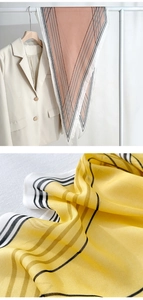 Close-up of geometric silk scarf textures and styling on a white suit blazer